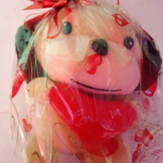 Peluche Perrito con Moño de Regalo                                                                                       Bonito peluche de perrito presentado en empaque transparente con moño decorativo Perfecto para detalles o regalos románticos